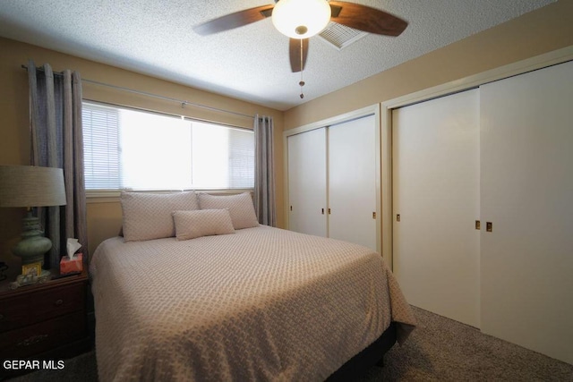 4313 Okeefe Dr, El Paso, TX 79902 - carpeted bedroom featuring two closets, ceiling fan, and a textured ceiling