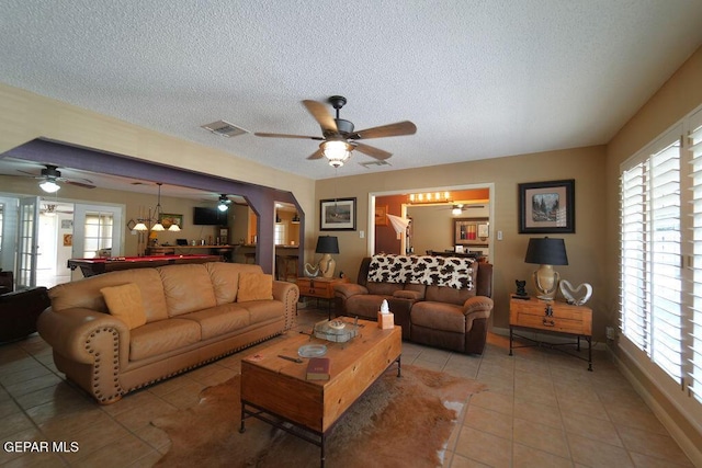 4313 Okeefe Dr, El Paso, TX 79902 - living room with light tile patterned floors, a textured ceiling, ceiling fan, and healthy amount of natural light