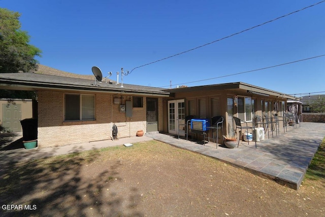 4313 Okeefe Dr, El Paso, TX 79902 - rear view of property featuring brick siding and a patio