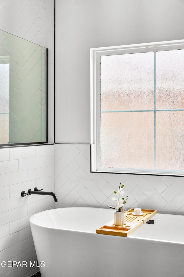 13380 Coldham St, El Paso, TX 79928 - bathroom with tile walls and a freestanding bath