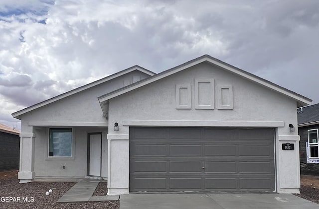 15221 Apex Ct, El Paso, TX 79938 - view of front facade featuring a garage, stucco siding, and concrete driveway