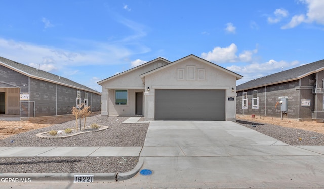 15221 Apex Ct, El Paso, TX 79938 - ranch-style house with a garage, driveway, and stucco siding