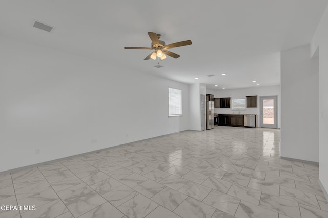 15221 Apex Ct, El Paso, TX 79938 - unfurnished living room with healthy amount of natural light, light marble finish floors, ceiling fan, and recessed lighting