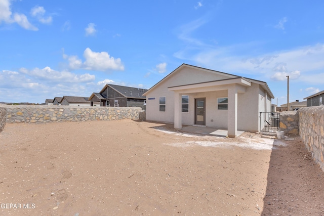 15221 Apex Ct, El Paso, TX 79938 - rear view of house with stucco siding, a fenced backyard, and a patio area