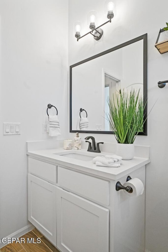 891 Dewsbury Way, El Paso, TX 79928 - bathroom with vanity, wood finished floors, and baseboards