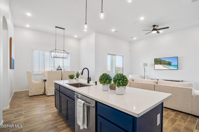 891 Dewsbury Way, El Paso, TX 79928 - kitchen featuring a sink, stainless steel dishwasher, open floor plan, wood finished floors, and blue cabinetry