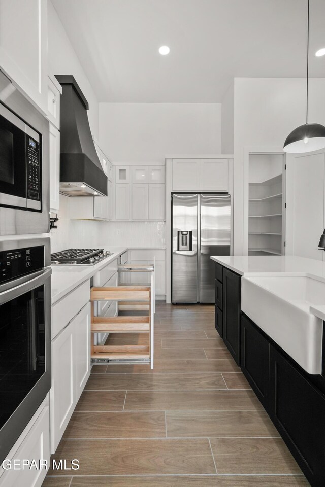 895 Dewsbury Way, El Paso, TX 79928 - kitchen with stainless steel appliances, premium range hood, a sink, white cabinets, and recessed lighting