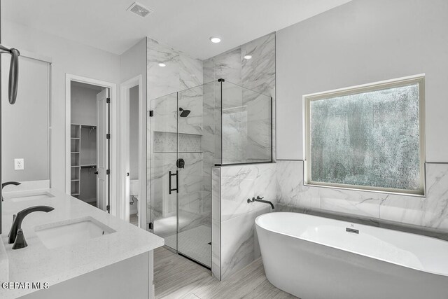 899 Dewsbury Way, El Paso, TX 79928 - bathroom with a marble finish shower, a soaking tub, toilet, double vanity, and tile walls