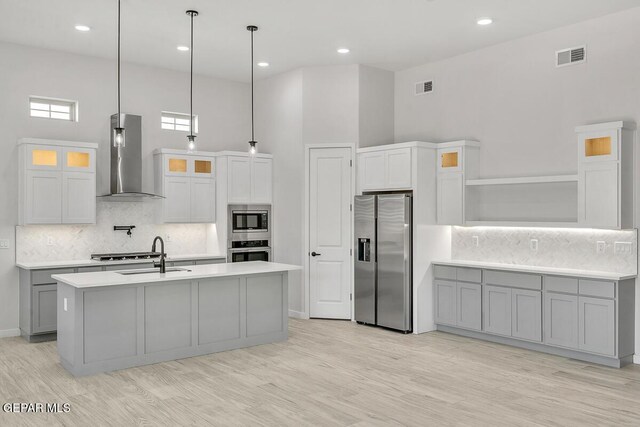 899 Dewsbury Way, El Paso, TX 79928 - kitchen featuring stainless steel appliances, wall chimney exhaust hood, open shelves, a sink, and light countertops