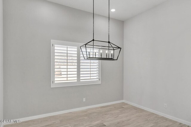 899 Dewsbury Way, El Paso, TX 79928 - spare room featuring wood finished floors, a chandelier, and baseboards