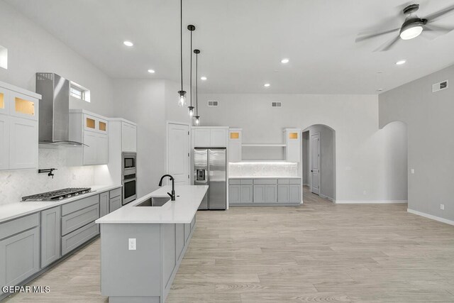 899 Dewsbury Way, El Paso, TX 79928 - kitchen with stainless steel appliances, wall chimney exhaust hood, arched walkways, a sink, and ceiling fan