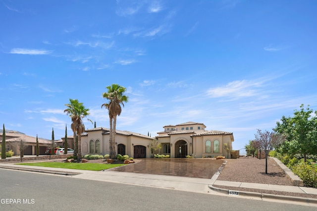 6572 Tuscany Ridge Dr, El Paso, TX 79912 - mediterranean / spanish-style home with curved driveway, stucco siding, and a tiled roof