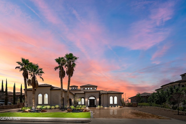 6572 Tuscany Ridge Dr, El Paso, TX 79912 - mediterranean / spanish-style home with stucco siding, a tile roof, and curved driveway