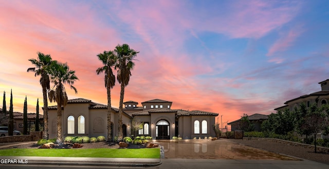 6572 Tuscany Ridge Dr, El Paso, TX 79912 - mediterranean / spanish-style home featuring curved driveway, a tile roof, and stucco siding