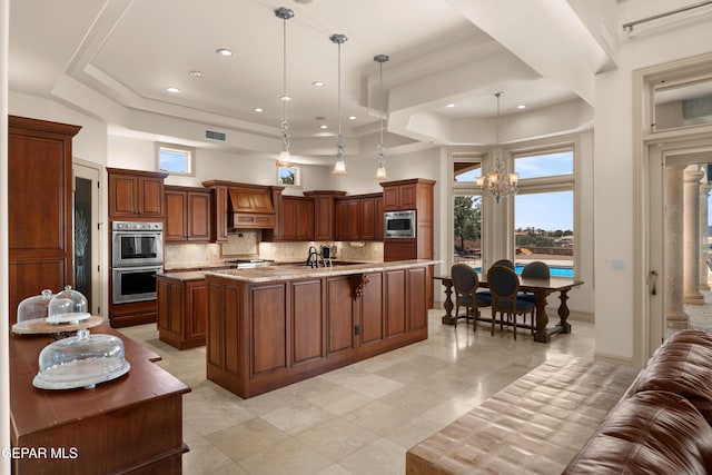 6572 Tuscany Ridge Dr, El Paso, TX 79912 - kitchen with stainless steel appliances, a large island, a chandelier, a raised ceiling, and a high ceiling