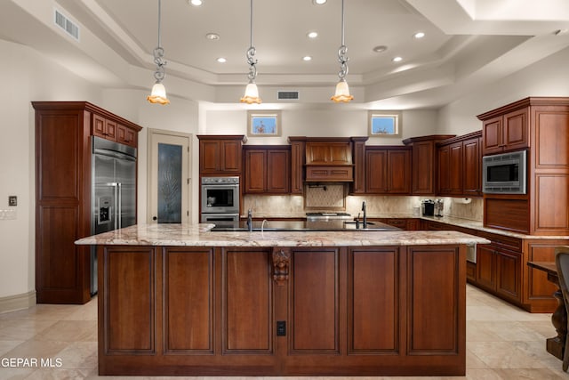 6572 Tuscany Ridge Dr, El Paso, TX 79912 - kitchen featuring built in appliances, decorative backsplash, a spacious island, a tray ceiling, and recessed lighting