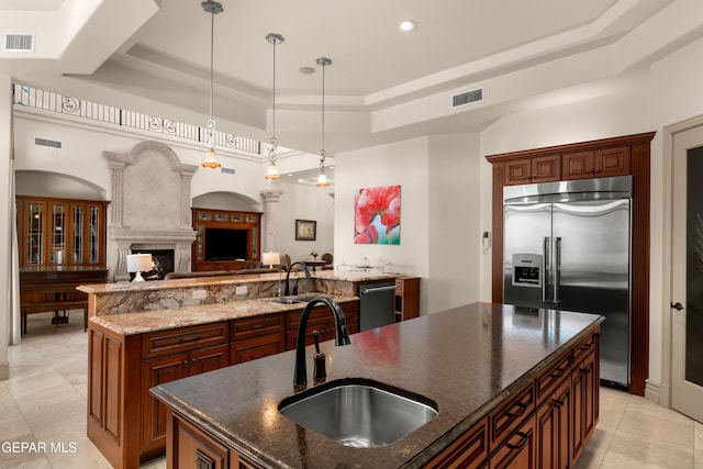 6572 Tuscany Ridge Dr, El Paso, TX 79912 - kitchen with appliances with stainless steel finishes, a large island with sink, a tray ceiling, light tile patterned floors, and recessed lighting