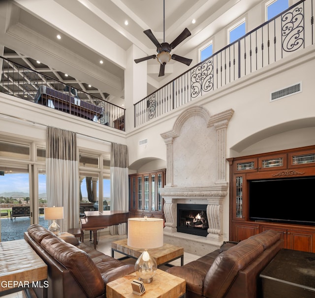 6572 Tuscany Ridge Dr, El Paso, TX 79912 - living area with a high ceiling, a ceiling fan, a high end fireplace, and recessed lighting