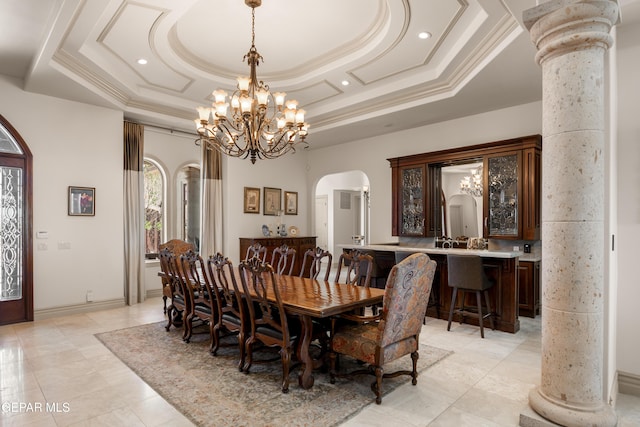 6572 Tuscany Ridge Dr, El Paso, TX 79912 - dining area featuring arched walkways, crown molding, a chandelier, a raised ceiling, and light tile patterned flooring