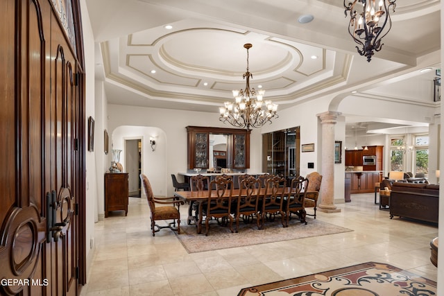 6572 Tuscany Ridge Dr, El Paso, TX 79912 - dining space with a chandelier, ornate columns, and arched walkways