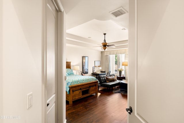 6572 Tuscany Ridge Dr, El Paso, TX 79912 - bedroom featuring dark wood finished floors, a tray ceiling, and a ceiling fan