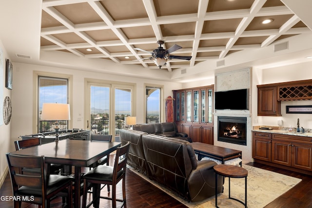 6572 Tuscany Ridge Dr, El Paso, TX 79912 - living room with a ceiling fan, dark wood finished floors, coffered ceiling, a lit fireplace, and recessed lighting