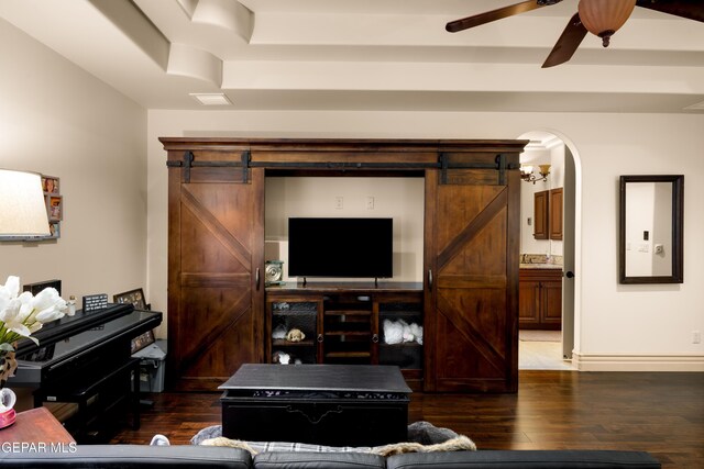 6572 Tuscany Ridge Dr, El Paso, TX 79912 - living area with a barn door, dark wood-type flooring, a ceiling fan, and a tray ceiling