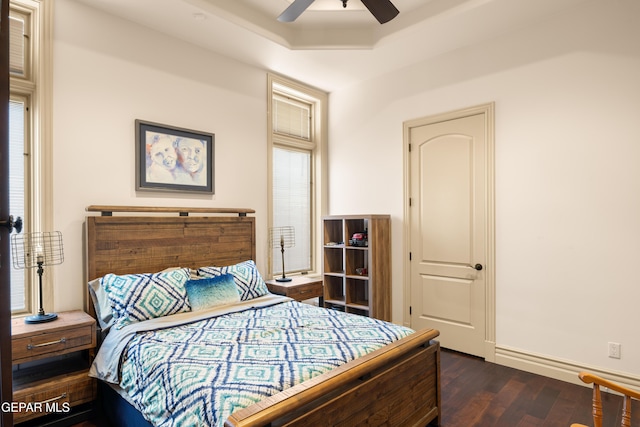 6572 Tuscany Ridge Dr, El Paso, TX 79912 - bedroom featuring dark wood finished floors, a raised ceiling, and ceiling fan