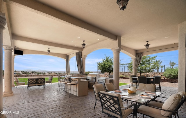 6572 Tuscany Ridge Dr, El Paso, TX 79912 - view of patio / terrace with an outdoor bar, an outdoor kitchen, and outdoor dining area