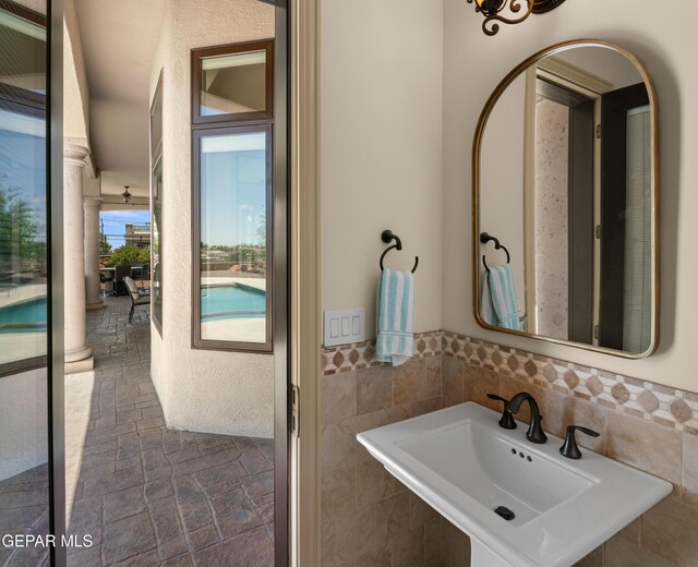 6572 Tuscany Ridge Dr, El Paso, TX 79912 - bathroom with stone tile floors and tile walls