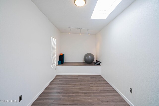 7573 Le Conte Dr Unit A, El Paso, TX 79912 - exercise room with wood finished floors, baseboards, and a skylight