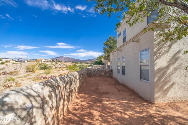 7573 Le Conte Dr Unit A, El Paso, TX 79912 - view of home's exterior with stucco siding and a mountain view