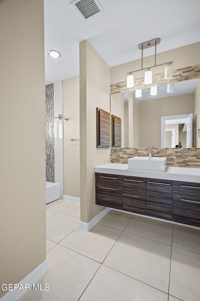 6071 Desert Whisper Ct, El Paso, TX 79912 - bathroom featuring tile patterned floors, vanity, baseboards, and tub / shower combination