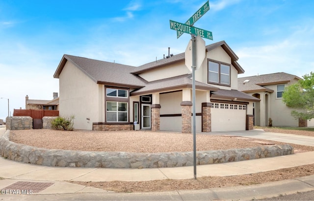 7101 Mesquite Tree Ln, El Paso, TX 79934 - view of front of home featuring an attached garage, stucco siding, concrete driveway, and stone siding