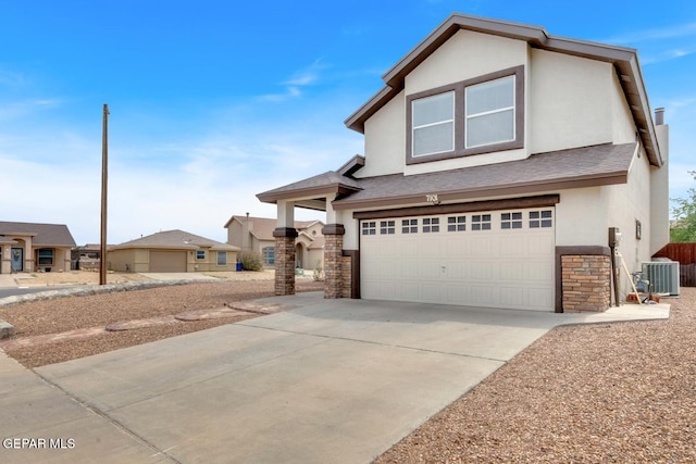 7101 Mesquite Tree Ln, El Paso, TX 79934 - view of front of home with stone siding, stucco siding, a garage, central AC, and a shingled roof