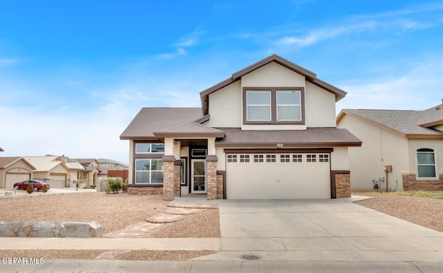 7101 Mesquite Tree Ln, El Paso, TX 79934 - view of front of house featuring stucco siding, stone siding, driveway, and an attached garage