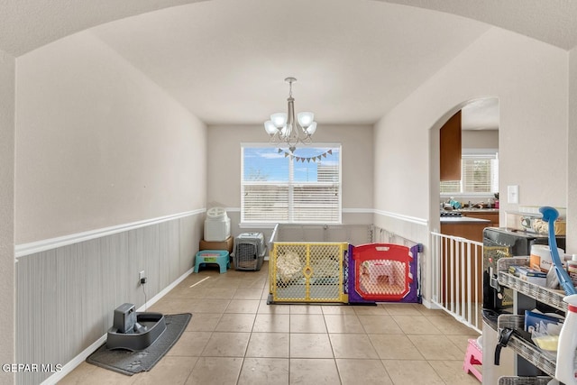 7101 Mesquite Tree Ln, El Paso, TX 79934 - playroom featuring arched walkways, light tile patterned flooring, and a chandelier
