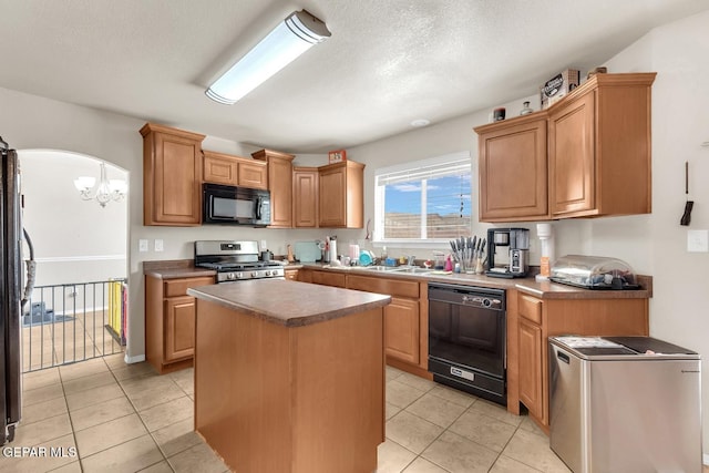 7101 Mesquite Tree Ln, El Paso, TX 79934 - kitchen featuring black appliances, a chandelier, a sink, light tile patterned floors, and a center island
