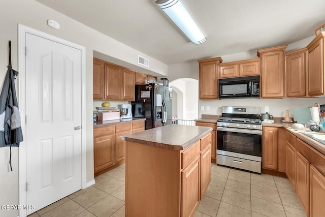 7101 Mesquite Tree Ln, El Paso, TX 79934 - kitchen featuring black appliances, arched walkways, a center island, and light tile patterned flooring
