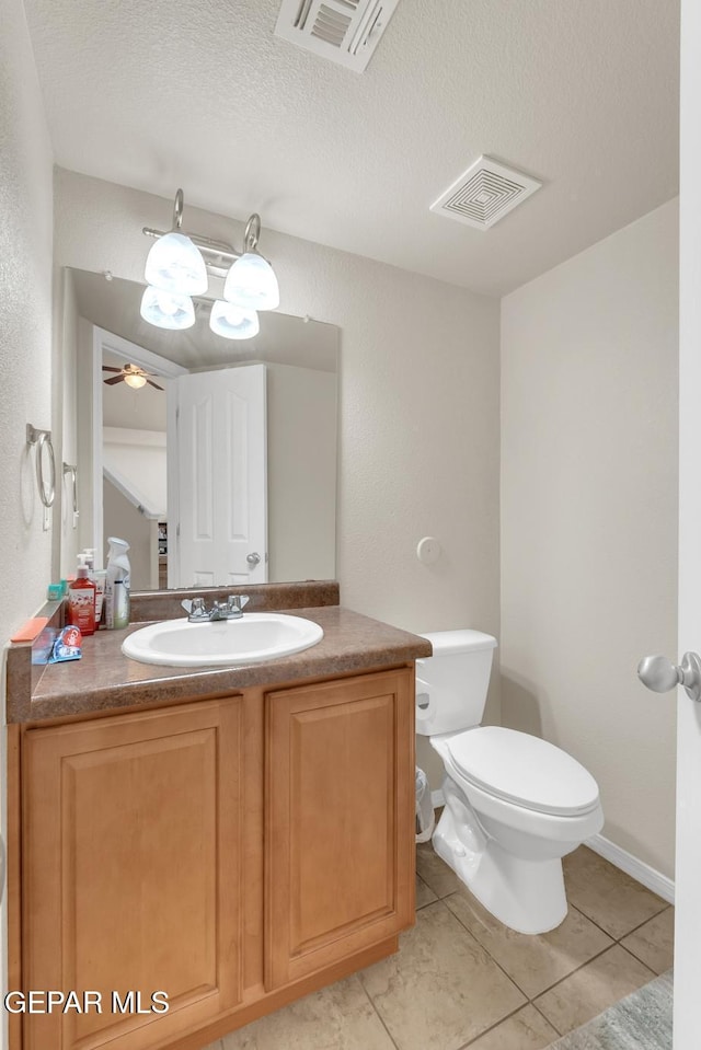 7101 Mesquite Tree Ln, El Paso, TX 79934 - bathroom featuring tile patterned flooring, toilet, vanity, a textured ceiling, and a ceiling fan