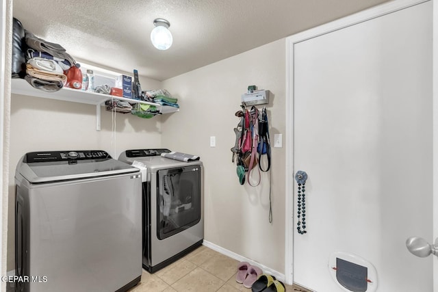 7101 Mesquite Tree Ln, El Paso, TX 79934 - washroom featuring independent washer and dryer, baseboards, a textured ceiling, and light tile patterned flooring