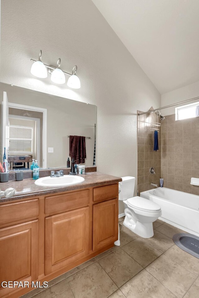 7101 Mesquite Tree Ln, El Paso, TX 79934 - bathroom with toilet, vanity, vaulted ceiling, shower / bath combination, and tile patterned floors