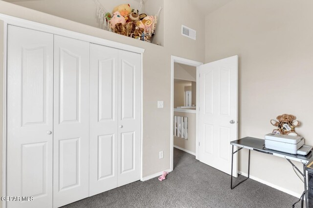 7101 Mesquite Tree Ln, El Paso, TX 79934 - bedroom with dark carpet, baseboards, and a closet