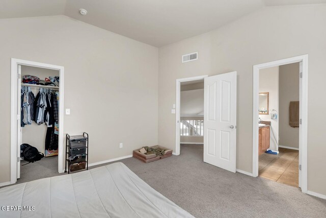 7101 Mesquite Tree Ln, El Paso, TX 79934 - carpeted bedroom featuring vaulted ceiling, a walk in closet, baseboards, a closet, and ensuite bath