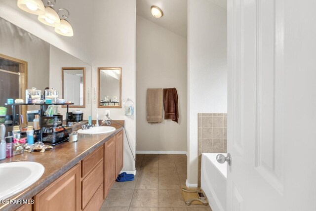 7101 Mesquite Tree Ln, El Paso, TX 79934 - bathroom with tile patterned flooring, double vanity, a garden tub, baseboards, and a shower with shower door