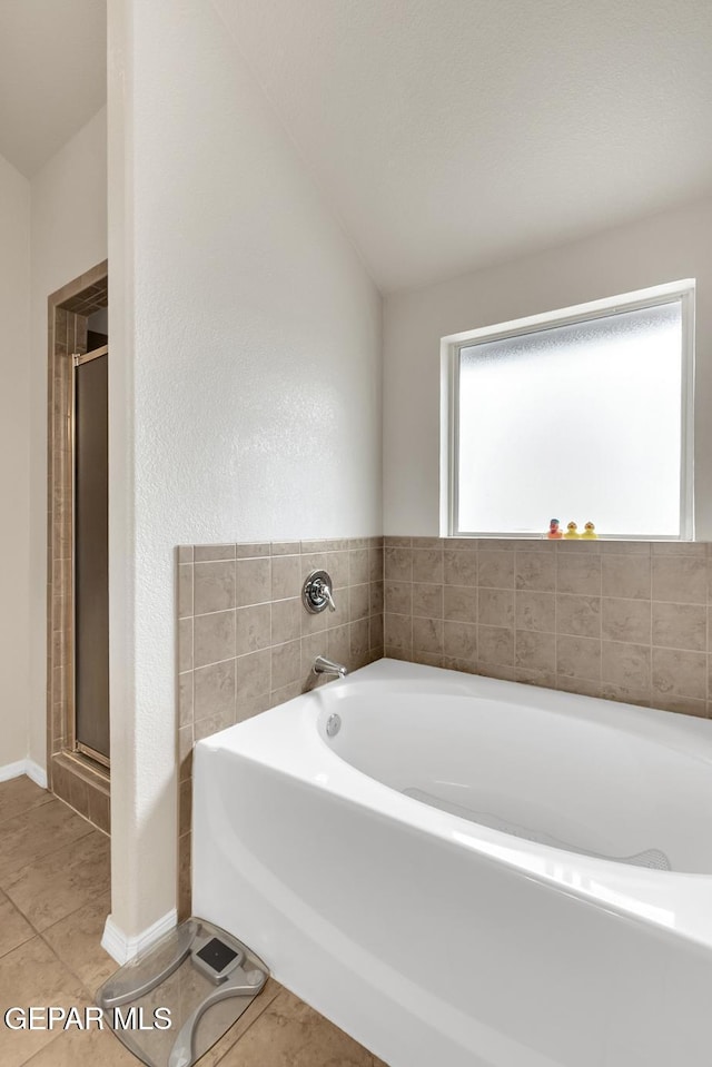 7101 Mesquite Tree Ln, El Paso, TX 79934 - bathroom with tile patterned flooring, a bath, and a stall shower