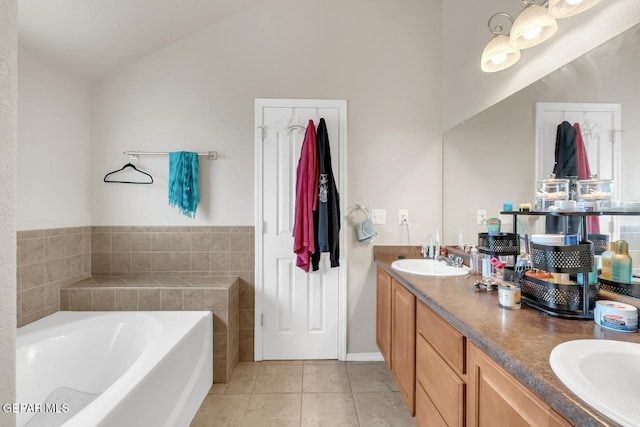 7101 Mesquite Tree Ln, El Paso, TX 79934 - bathroom featuring vaulted ceiling, a bath, double vanity, and tile patterned flooring