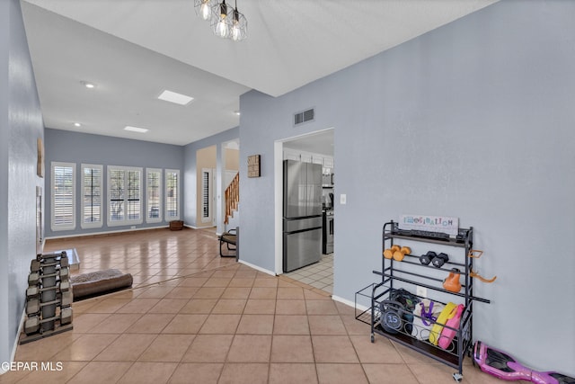 6101 Via Suerte Ave, El Paso, TX 79912 - spare room featuring stairway, light tile patterned flooring, and baseboards