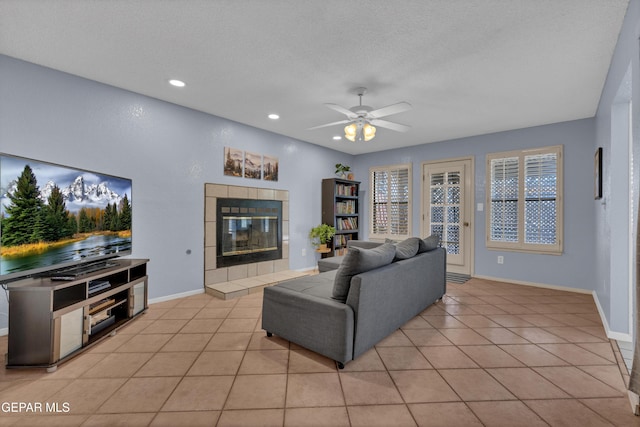 6101 Via Suerte Ave, El Paso, TX 79912 - living room featuring ceiling fan, a fireplace, recessed lighting, light tile patterned floors, and baseboards