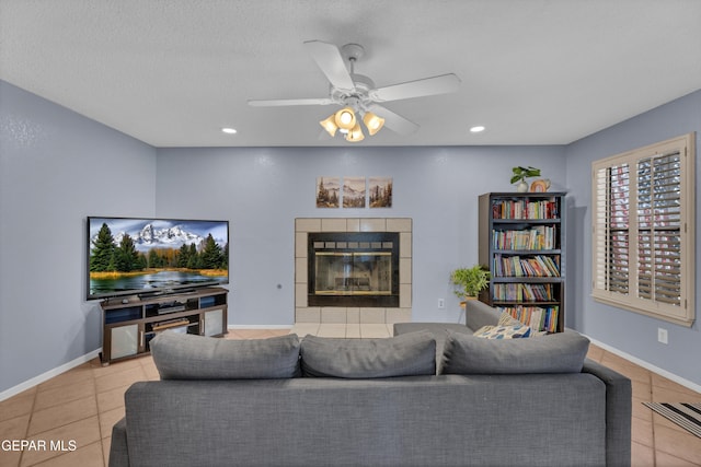 6101 Via Suerte Ave, El Paso, TX 79912 - tiled living room featuring a tiled fireplace, ceiling fan, recessed lighting, and baseboards